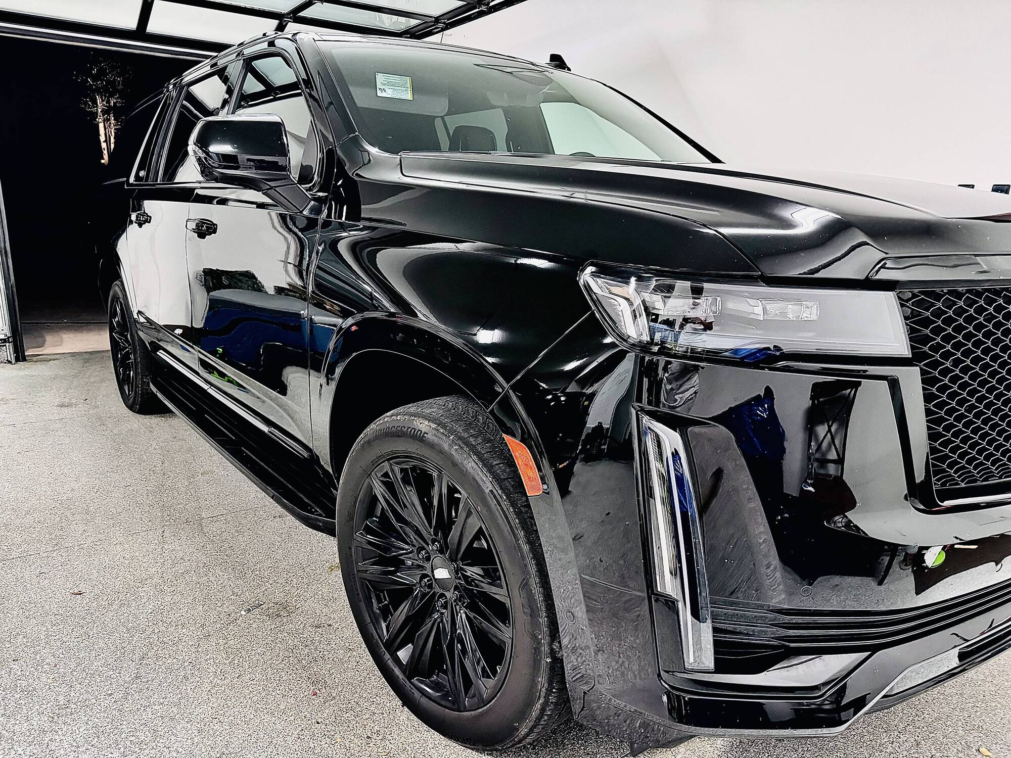 Black Cadillac Escalade with a deep gloss finish after detailing
