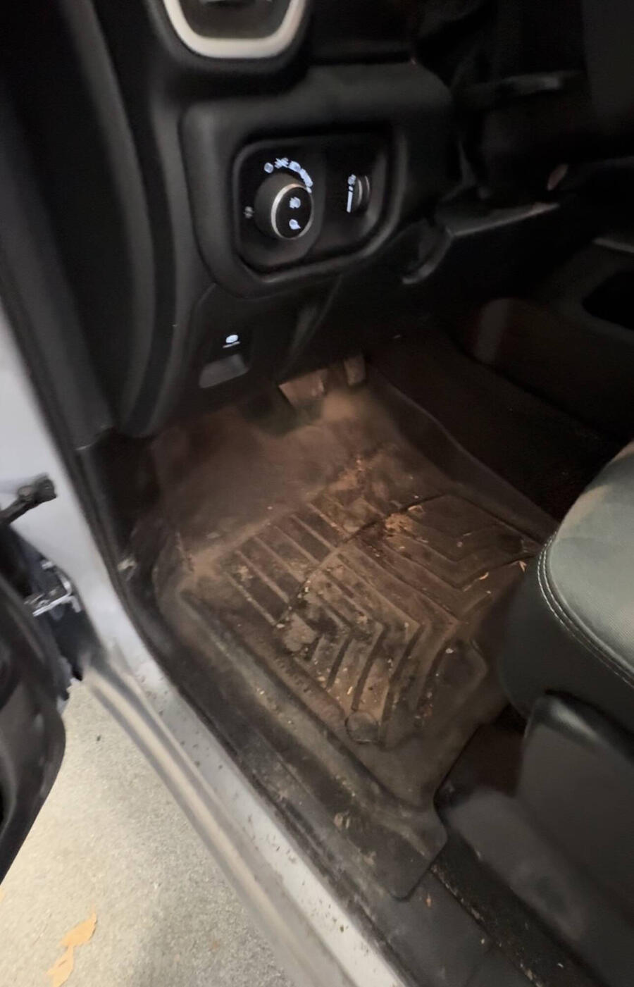 Dirty, mud-covered truck floor mat before detailing